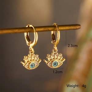 Detailed macro view of 18K gold-plated Evil Eye earrings with blue and white zircon
