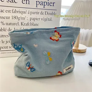 Sky blue cotton makeup bag with colorful butterfly embroidery and zipper closure