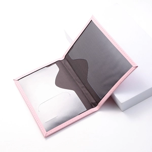 Detailed close-up of pink PU leather passport cover with interior card slots and stitching