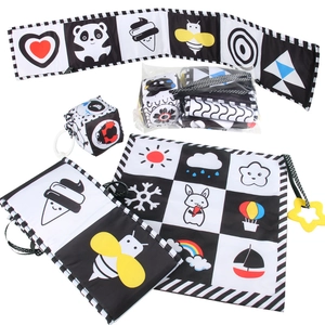 Close-up of high-contrast black and white fabric book set for newborn sensory stimulation