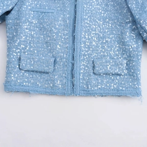 Women's light blue tweed jacket featuring shiny sequins and textured fringe details