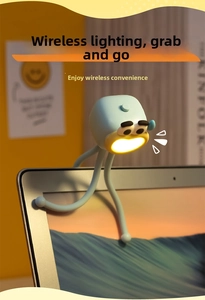 Mini octopus LED night light with flexible legs attached to a laptop screen for cozy desk lighting
