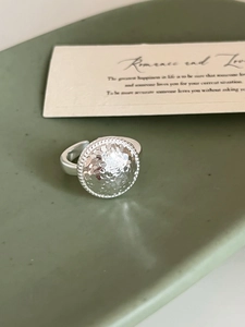 Detailed macro view of the silver hammered texture on the adjustable open ring band