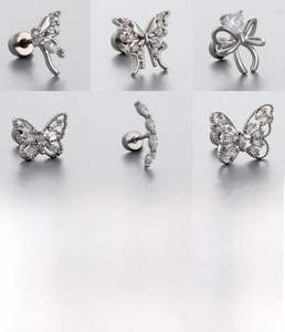 Detail of silver titanium steel stud earrings with zircon butterfly and bow designs