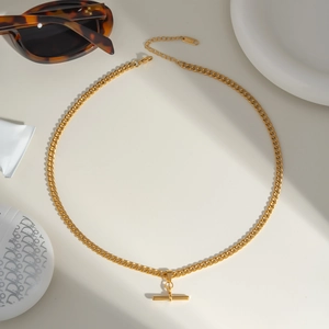 Flat lay of golden stainless steel Cuban chain necklace with T-bar pendant and sunglasses