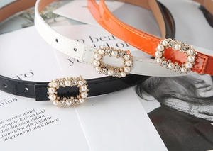 Chic skinny patent leather belts with pearl and rhinestone buckles in black, white, and orange