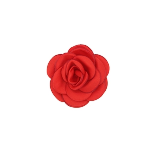 Detailed view of handcrafted red satin camellia flower for hair and garment accessories