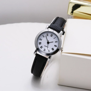 Close-up of vintage quartz watch with Roman numerals, silver case, and black leather strap