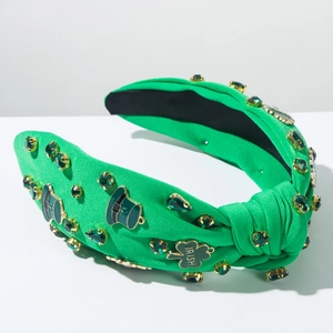Detail view of St. Patrick's Day headband with green crystals and Irish clover charm