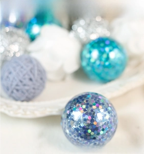 Macro shot of light blue-purple Christmas ball with shimmering sequins for DIY decor