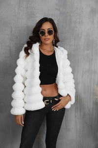 Detail of white faux fur jacket featuring distinctive bubble texture and plush hooded design