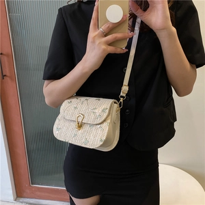 Straw saddle bag with green floral embroidery and gold clasp for summer style