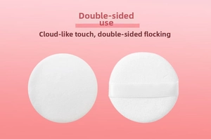 Detail of double-sided white crystal velvet powder puff with soft ribbon handle