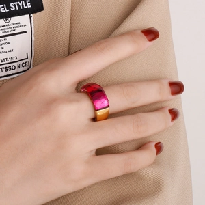 Detail of a gold cocktail ring with a large rectangular rose pink faceted gemstone