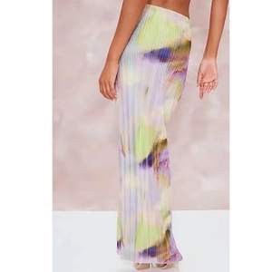 Detail of long pleated skirt with abstract watercolor print and vertical accordion pleats