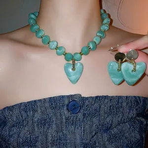 Elegant turquoise heart jewelry set with beaded necklace and matching earrings