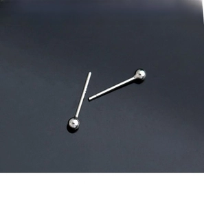 Macro detail of polished 925 sterling silver ball stud earrings showing glossy metallic texture
