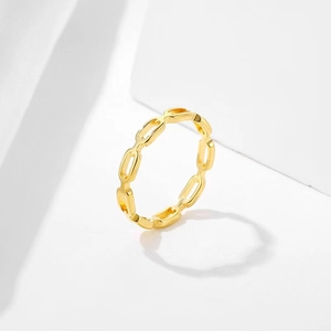 Polished gold titanium steel ring with hollow link chain design on white background