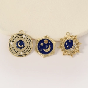 Three celestial gold pendants with blue enamel sun, moon and star motifs for DIY jewelry