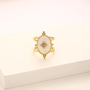 Close-up of golden double-ring with oval mother of pearl and star engraving motif