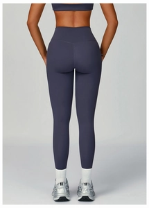 Rear view of high waisted dark purple yoga leggings and matching sports bra set