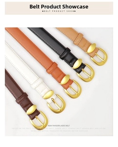 Close-up of five colorful leather belts with golden horseshoe buckles and metal eyelets