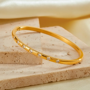 Elegant gold-plated stainless steel bangle featuring seven round sparkling zircons