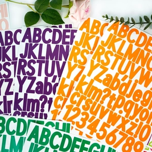 Macro shot of 1.5 inch colorful alphanumeric stickers with bold font on white background