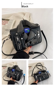 Detail view of black PU leather punk jacket bag with silver rivets and blue text patch