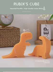 Macro detail of cute orange dinosaur scented candles with high-quality cotton wicks
