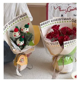 Detail of Christmas bouquet wrapping paper with crochet snowmen and red roses motifs