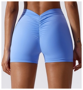 Detail of light blue high-waisted yoga shorts with V-cut waistband and ruched butt lift effect