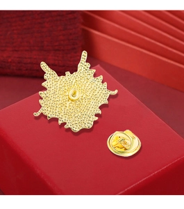 Detailed macro view of gold metal dragon brooch back with a secure butterfly clutch pin