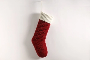 Detailed view of red and white knitted Christmas stocking with fish scale weave pattern