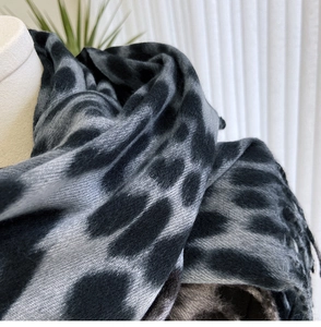 Close-up of leopard print cashmere feel scarf with detailed texture and fringe
