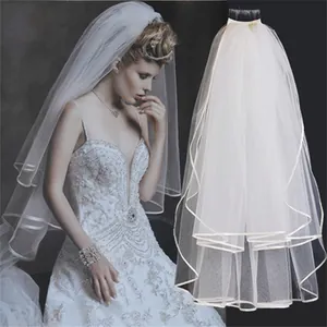 Elegant white two-layer bridal veil with ribbon edge and hair comb for wedding