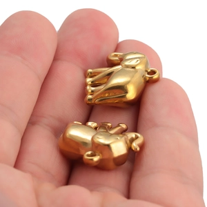 Pair of 18k gold plated vintage elephant charms held in palm showing compact size