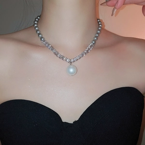Detail of necklace with grey pearls, crystal pavé chain and large white pearl pendant