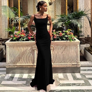 Detail of elegant black slim fit backless maxi dress showing textured fabric folds