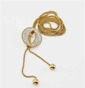 Macro view of gold plated oval pendant with shimmering white zircon crystal inlay