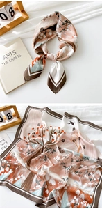 Detailed view of square silk scarf featuring artistic bird and floral patterns