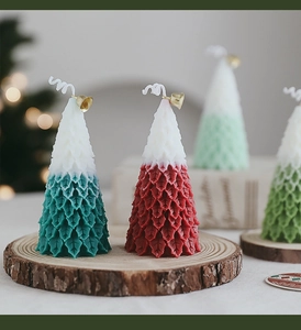 Detailed view of Christmas tree candles with layered textures and festive gold bells