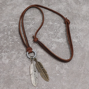 Vintage adjustable brown leather necklace featuring silver and bronze feather pendants