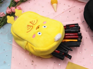 Detail of yellow plush cartoon pencil case with crown decor and zipper storage space