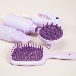 4-piece purple hair care set including fine mist spray bottle, brush and scalp massager