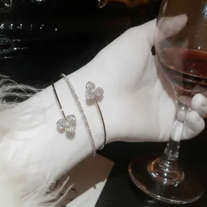 Elegant silver layered open bracelet with cubic zirconia flowers and white pearls
