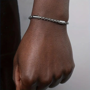 Polished stainless steel square pearl and dumbbell link bracelet on wrist for women