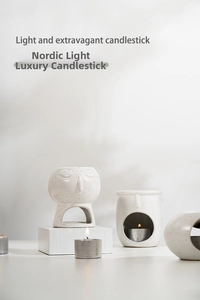 Macro detail of Nordic white ceramic candle holders with minimalist abstract face relief