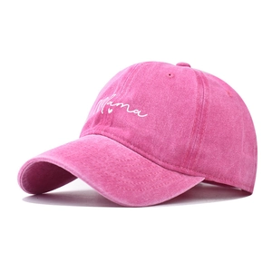 Detail of pink washed cotton baseball cap with white Mama embroidery and heart