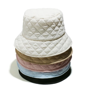 Vertical stack of quilted bucket hats in cream, khaki, pink, blue and black colors